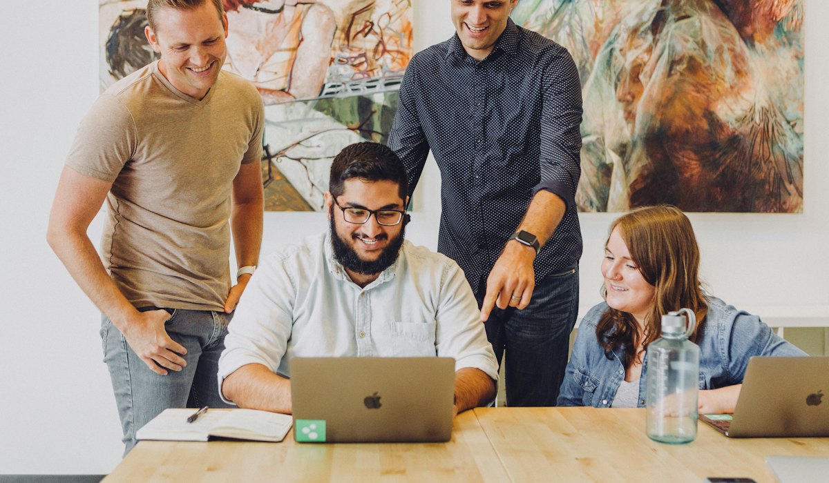 Team working around a laptop