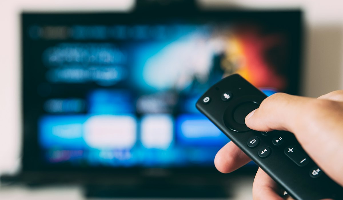 Hand holding a TV remote